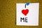 I love me reminder note - handwriting in black ink on an on cork board background.