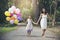 I love mom stay together on mothers day.Adorable cute girl holding balloons with mother