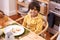 I love moms cooking. A portrait of a cute young boy sitting at the dinner table.