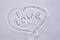 I love in my heart. Declaration of love in the snow. Snowy words of love. Text written on the surface of the snow