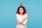 I love myself. Attractive hipster woman with fancy red hair and funny party cone on head supporting