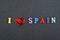 I love SPANISH word on black board background composed from colorful abc alphabet block wooden letters, copy space for