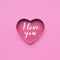 I love you on heart shape paper in pink color