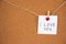 I love you lettering written on white paper pinned with small felt-hearted latch on cork board