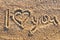 I love you message written in golden sand