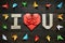 I LOVE YOU, U folded letters and red heart. Colored origami paper butterflies frame on dark brown aged wood background. Valentines