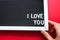 I love you in white letters on a framed blackboard. Whiteboard for entries and tags. Valentine`s Day, a declaration of love, a