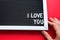 I love you in white letters on a framed blackboard. Whiteboard for entries and tags. Valentine`s Day, a declaration of love, a