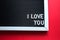 I love you in white letters on a framed blackboard. Whiteboard for entries and tags. Valentine`s Day, a declaration of love, a