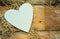 I love you - white, simple heart cut from wood on a romantic, simple rustic background, with space for text