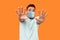 I`m afraid! Portrait of scared terrified man with medical mask in white t-shirt making frightened gesture with raised hands, pani