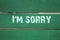 I`m sorry- phrase written on old green background