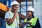 I might have an idea on materials. two young contractors standing in the warehouse and having a discussion while doing a