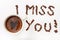 I miss you sign with coffee beans and cup of coffee