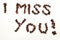 I miss you sign with coffee beans over white background