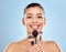 I am in the mood for glamour. Studio portrait of an attractive young woman holding a collection of makeup brushes