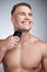 I am my biggest flex. Studio shot of an attractive young man shaving his face against a grey background.