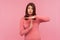 I need break! Tired upset brunette woman in pink sweater showing time out gesture, stop or limit hand sign, deadline