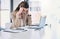 I need a miracle to make it through today. a young businesswoman looking stressed out while working on a computer in an