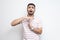 I need more time. Portrait of pleased handsome bearded young man in striped t-shirt standing with time out gesture and looking at