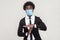 I need more time. Portrait of worry young worker man in black suit with surgical medical mask standing with timeout gesture and