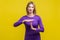 I need more time. Portrait of young woman showing time out or pause gesture. indoor studio shot  on yellow background