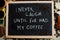 I never laugh until i`ve had my coffee. Words on blackboard flat lay