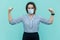 I am strong and I will be healthy. Portrait of proud satisfied middle aged woman with surgical medical mask standing with raised