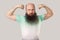 I am strong and independent. Portrait of serious middle aged bald bearded man in green t-shirt standing in bodybuilding pose and