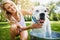 I think I actually like this...a woman bathing her pet dog outside on a summers day.