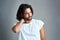 I think I might have slept funny. Studio shot of a handsome young man experiencing neck ache against a grey background.