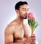 I think youre beautiful. Studio shot of a man smelling a protea flower.