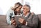 I told you wed find big bargains online. a mature couple using a digital tablet and credit card to do online shopping at