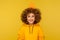 I wish home! Portrait of happy joyful curly-haired young woman in urban style hoodie looking up at paper house