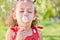 I wish... summer would stay a little longer. Shot of an adorable little girl blowing a dandelion while sitting at the