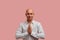 Iam just from asia. Photo of handsome relaxed bald guy in white shirt, holds palms in pray, smiles positively, greets