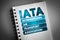 IATA - International Air Transport Association acronym on notepad, concept background