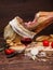 Iberian ham pata negra from Spain, tomatoes, onion rings and red wine glass. Closeup vertical image