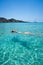 Ibiza bikini girl swimming clear water beach