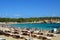 IBIZA, SPAIN - SEPTEMBER 1, 2016: amazing crystalline water of Cala Bassa beach with umbrellas and beach chairs, Ibiza, Spain