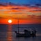 Ibiza sunset view and fisherboat formentera
