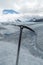 Ice axe fixed on frozen ice