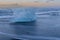 Ice braking on black sand beach seacoast skyline