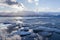 Ice breaking lake with sky reflection