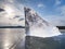 Ice breaking in pure nature. View over frozen water lake with sunset