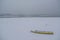 Ice capured yellow boat on frozen Danube river