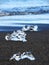 Ice Chunks Scattered on Black Sand at Diamond Beach in Iceland