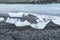 Ice chunks washed up on the black sand beach of rocks. Diamond Beach, Iceland