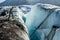 Ice climber looking into a huge crevasse on the Matanuska Glacier