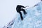 Ice climber scaling ice wall